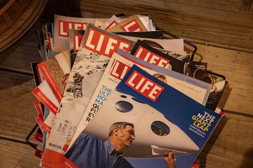 Stack of past El Vicentino magazines showing various covers
