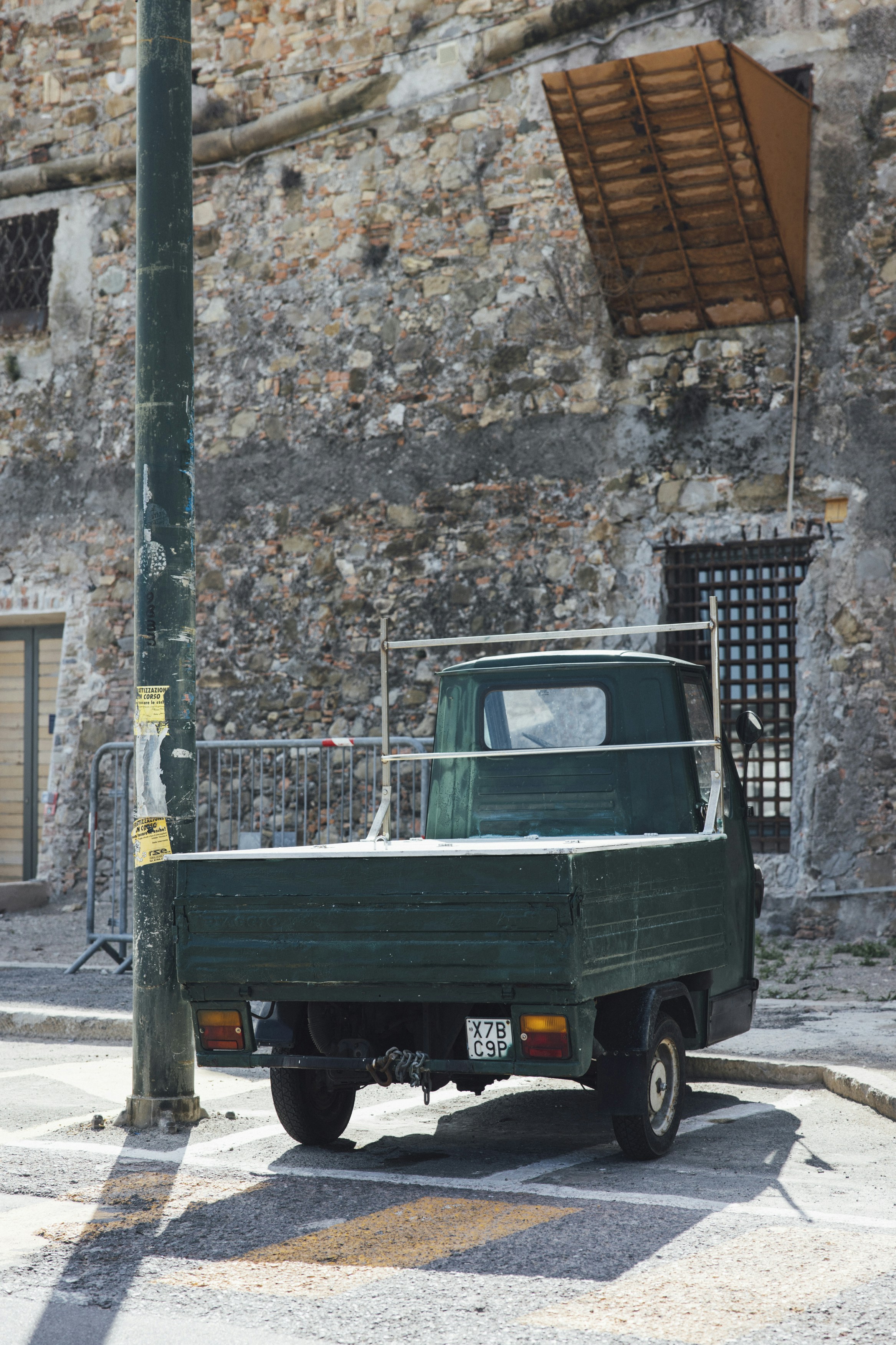 a green pick up truck parked on the side of the road