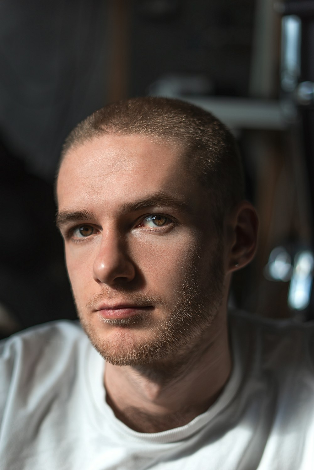 a man in a white shirt looking at the camera