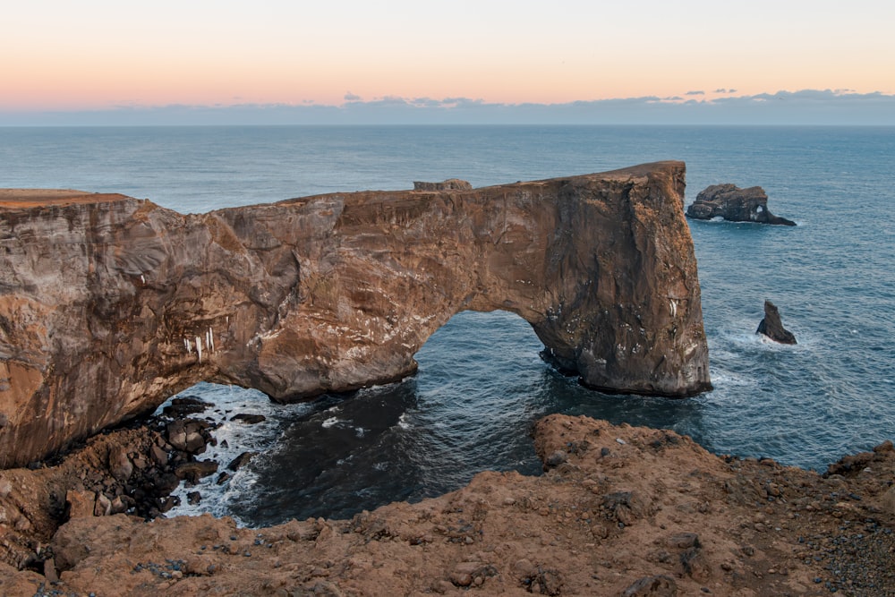 un grande ponte di roccia su uno specchio d'acqua