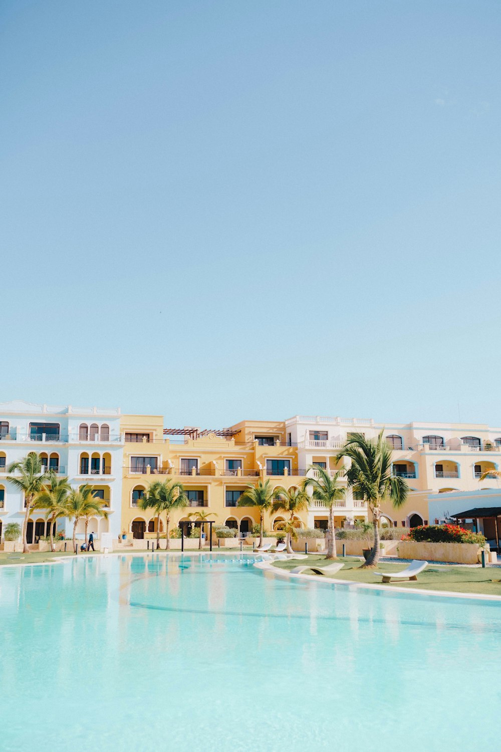 a large swimming pool in front of a multi - story building