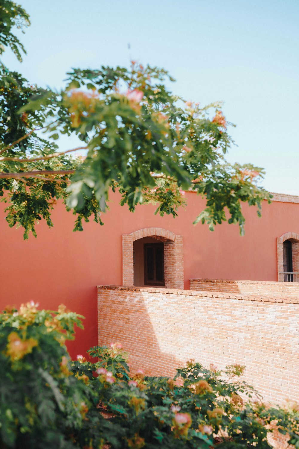 a red building with a clock on the side of it