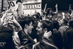 A group of people celebrating with phones in hand, showing excitement from a promotion