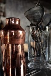 a close up of a metal vase on a table