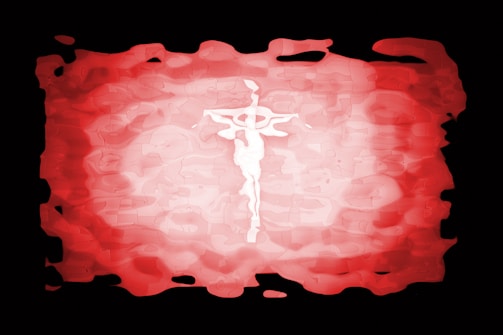 A stylized depiction of a crucifix in the center set against a textured, abstract background. The colors blend from a bright white at the center to deep reds and blacks, creating a dramatic contrast.