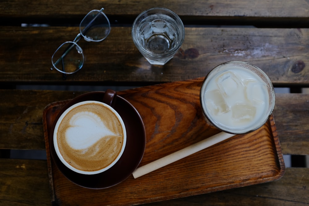 a wooden tray topped with a cup of coffee