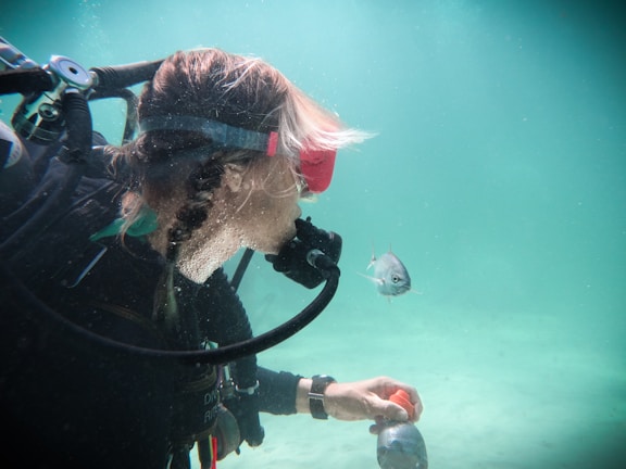 A technician carefully inspecting a scuba regulator in a workshop.
