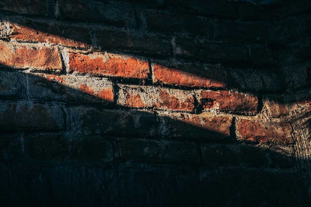 a brick wall with a light coming through it