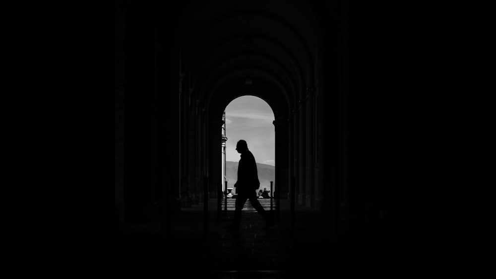 a person walking through a dark tunnel