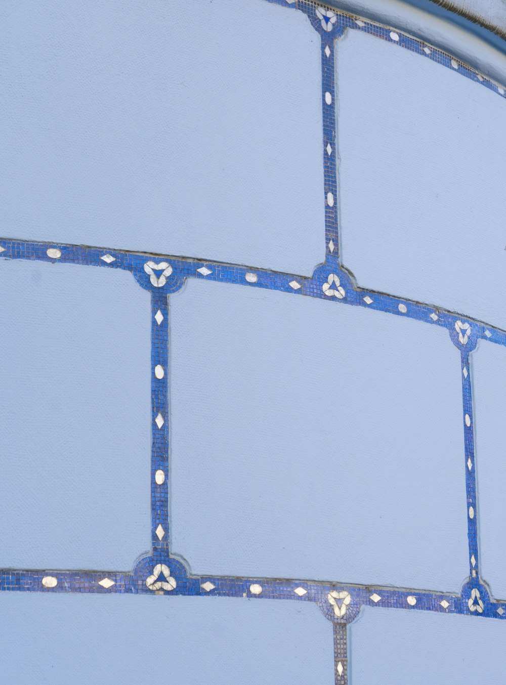 a close up of a metal structure with blue paint