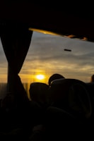 A couple enjoying a sunset view from a luxury vehicle.