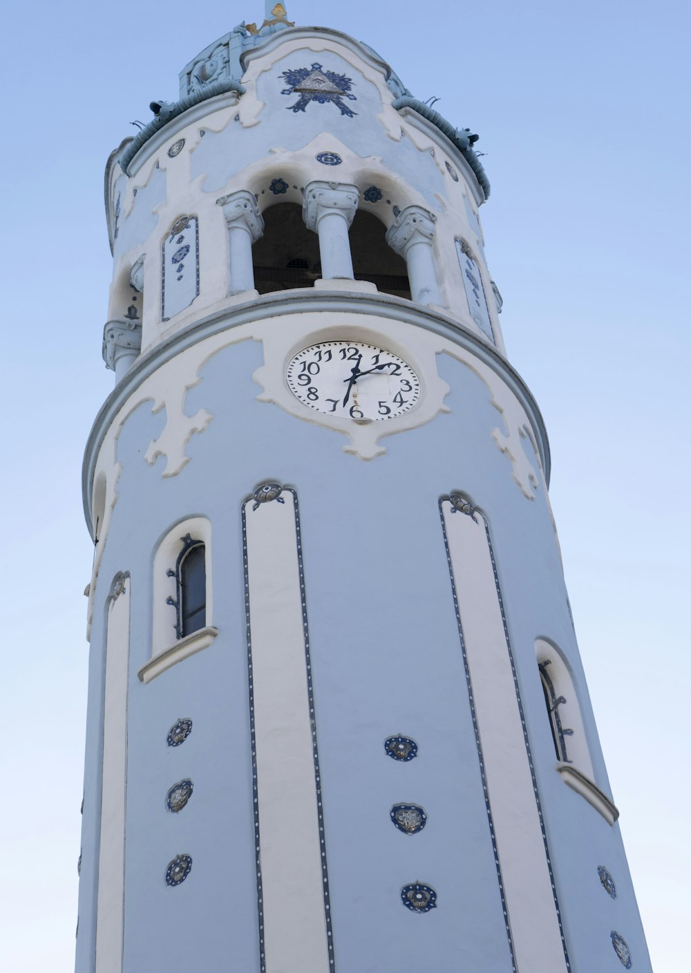 a tall clock tower with a clock on each of it's sides