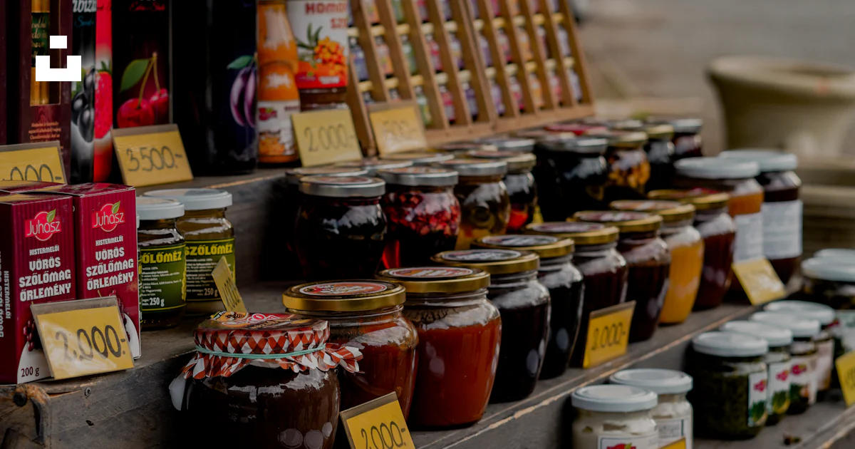 Table Jam A wooden table topped with lots of different types of jams photo – Free ...