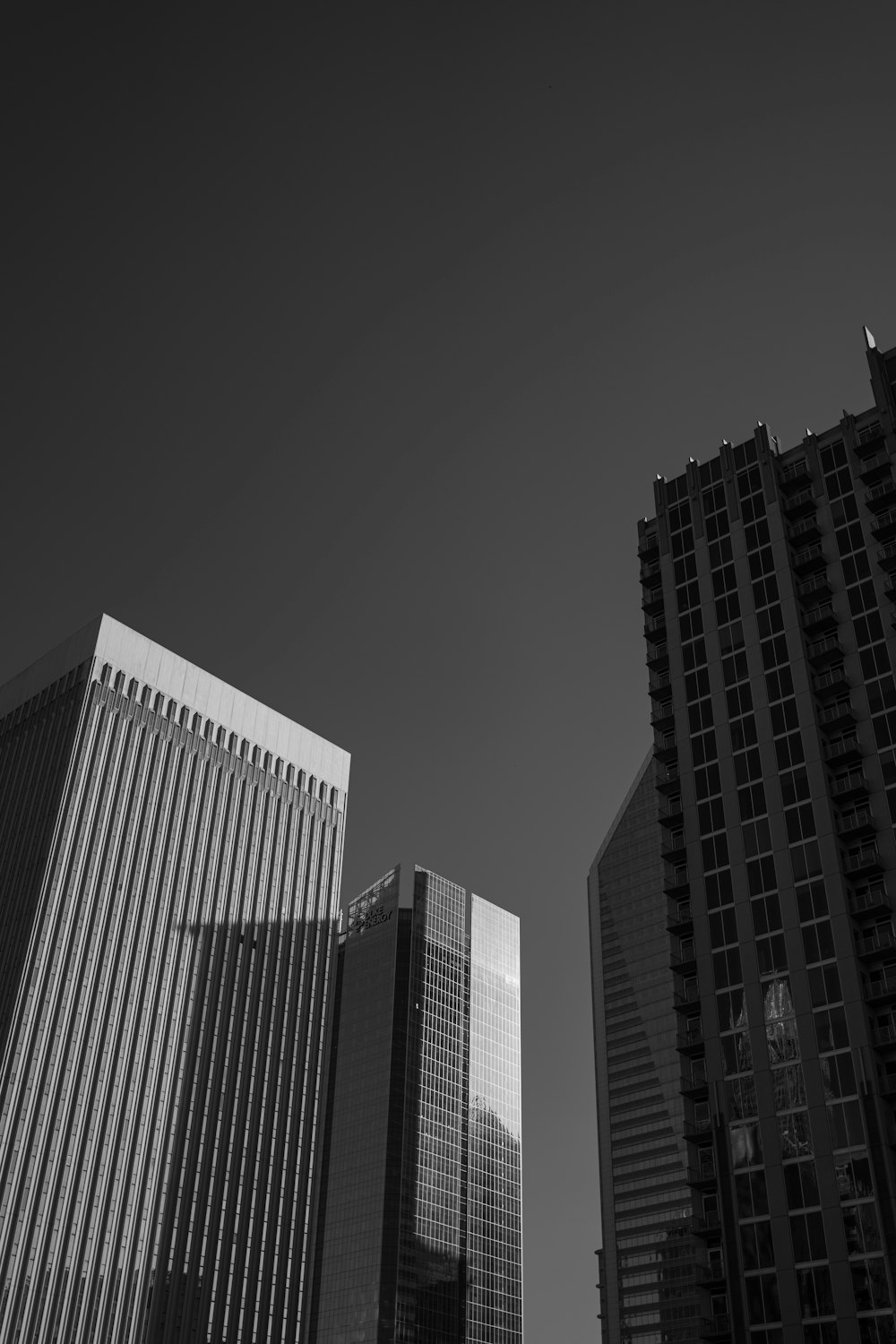 a black and white photo of skyscrapers in a city