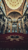 Colorful prayer rugs laid out under the sacred dome inside the mosque.