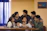 A group of union members gathered warmly around a table during a meeting.
