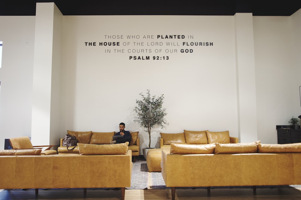 a man sitting on a couch in a living room