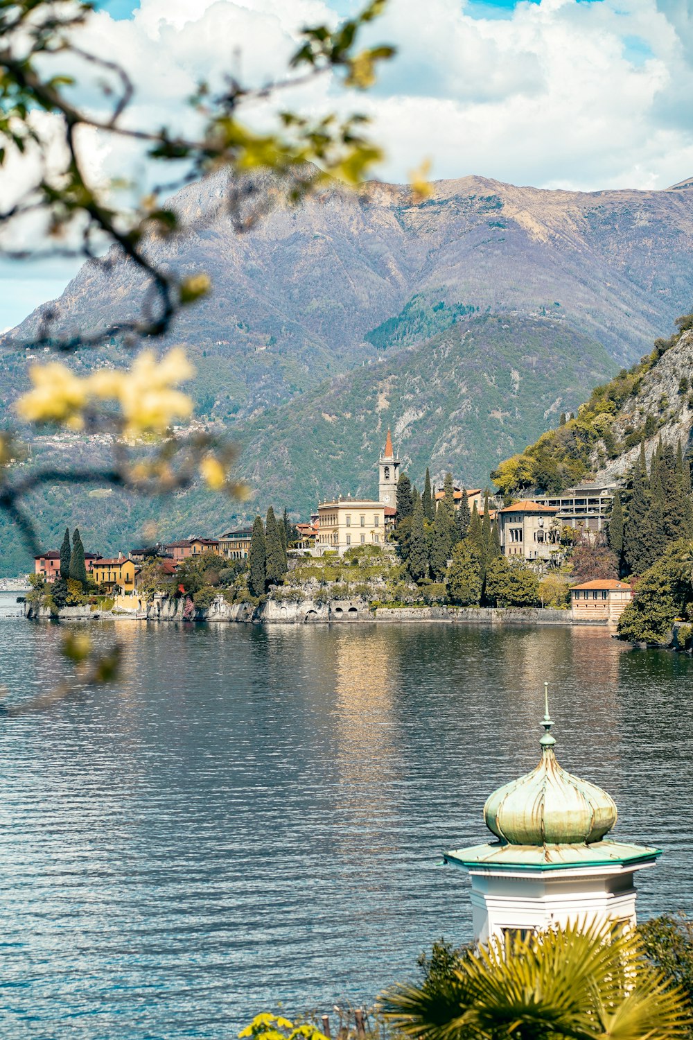 a scenic view of a lake with a church in the background