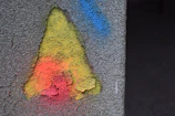 Close-up of a vibrant logo-inspired color palette on a textured wall.
