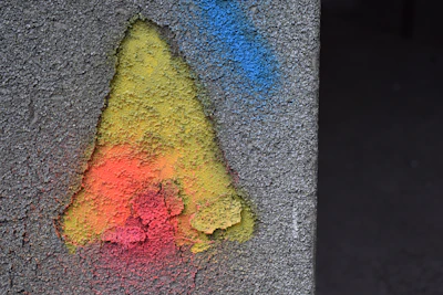 Close-up of a vibrant logo-inspired color palette on a textured wall.