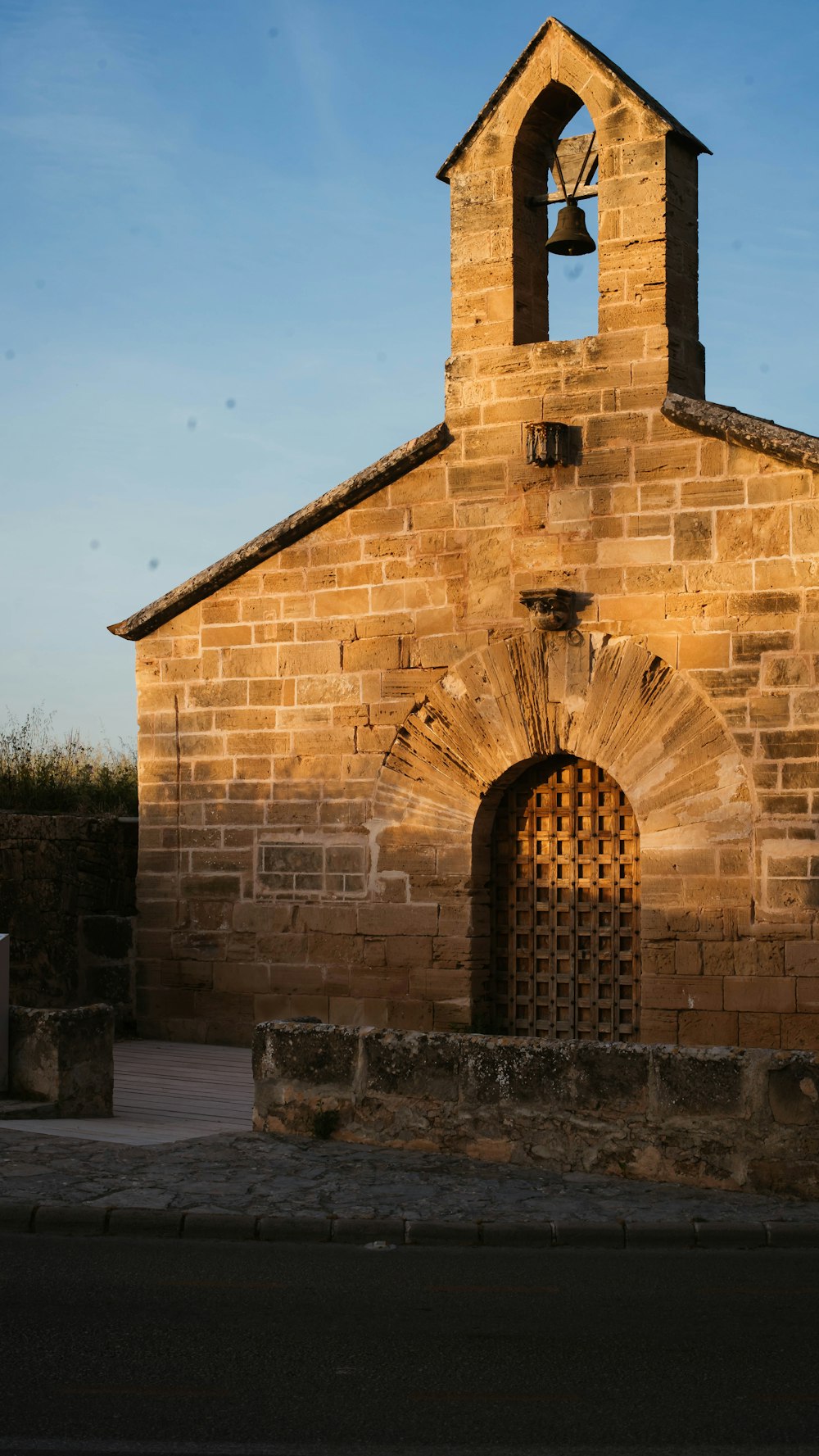 an old church with a bell on the top of it