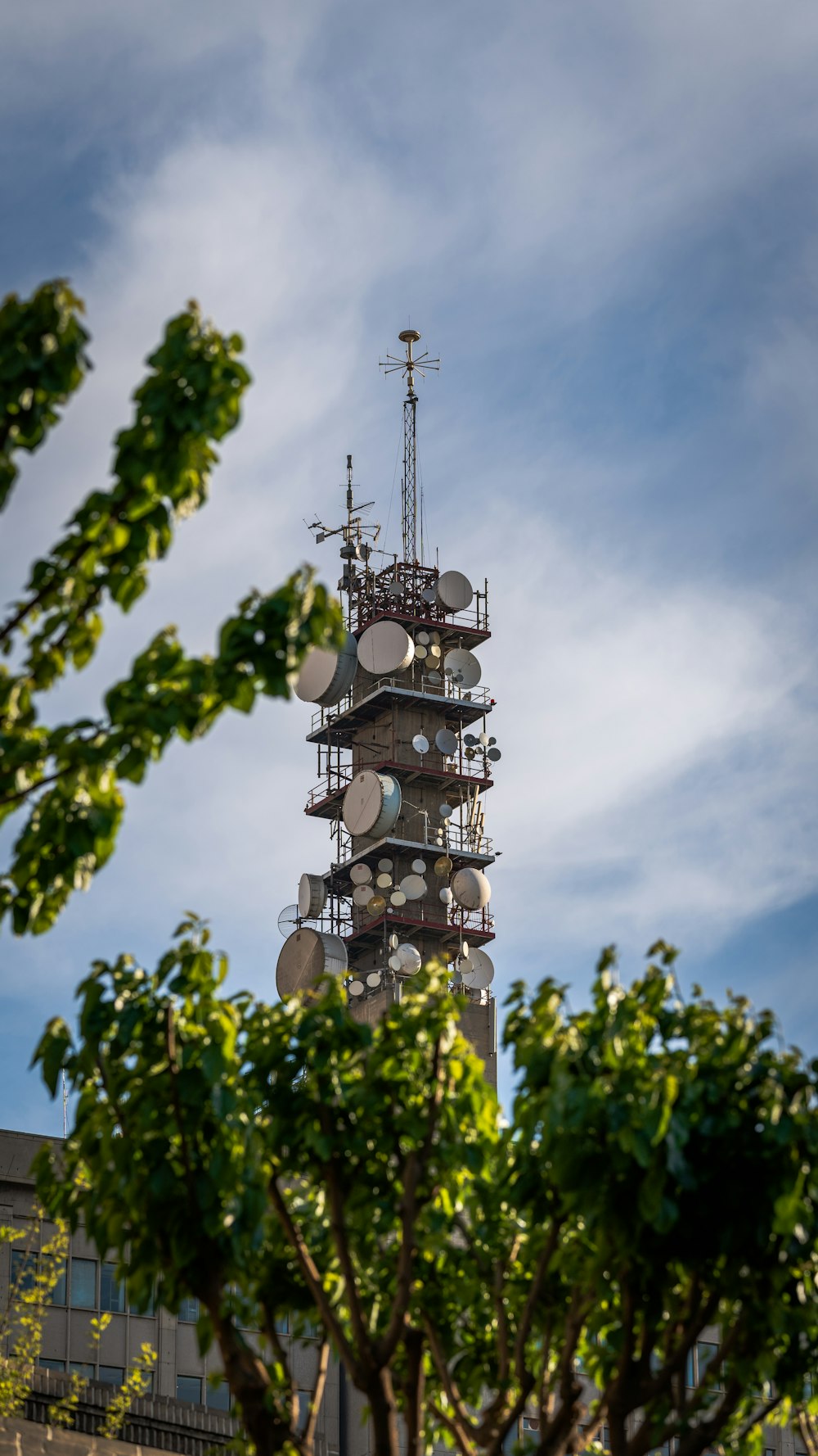 a tall tower with a lot of antennas on top of it