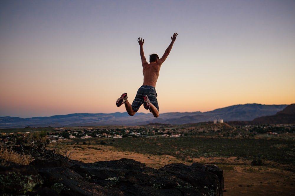 a man jumping in the air with his shirt off