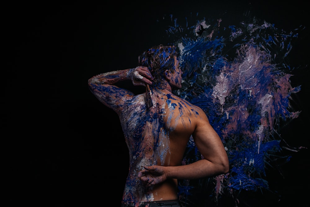 a man covered in blue and purple paint