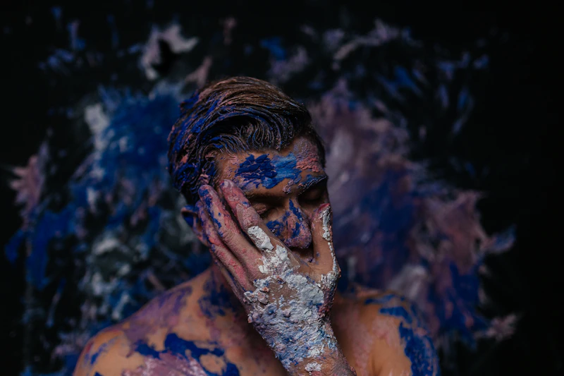 expressive man in blue and white body paint