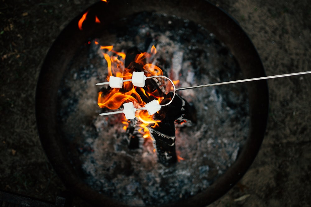 marshmallows on a stick over a campfire