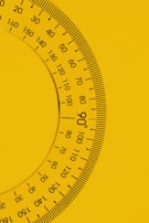 a close up of a yellow and black clock