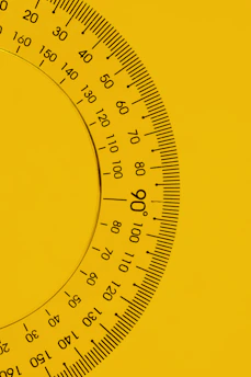 a close up of a yellow and black clock