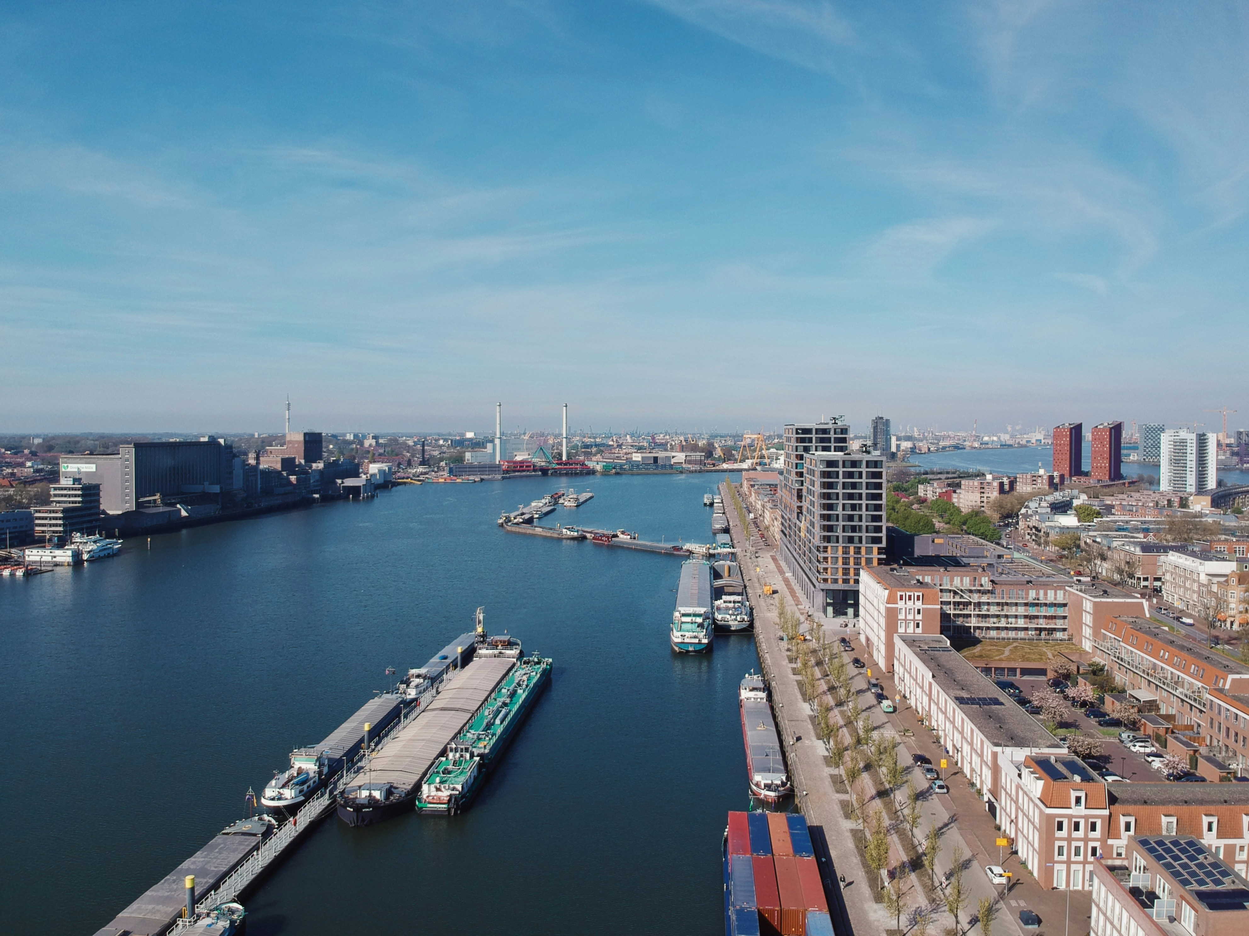 Large oil tankers docked at Rotterdam port facilities with loading infrastructure