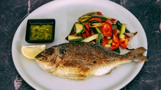 A colorful platter of grilled fish with lemon and local spices, ready to be enjoyed.