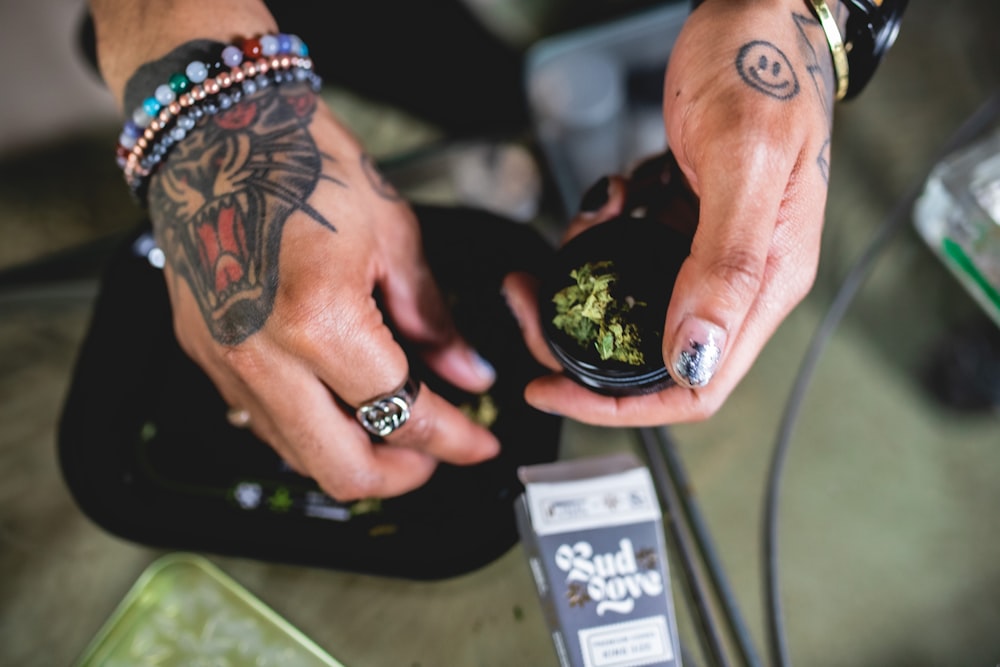 a person holding a bag of marijuana in their hands