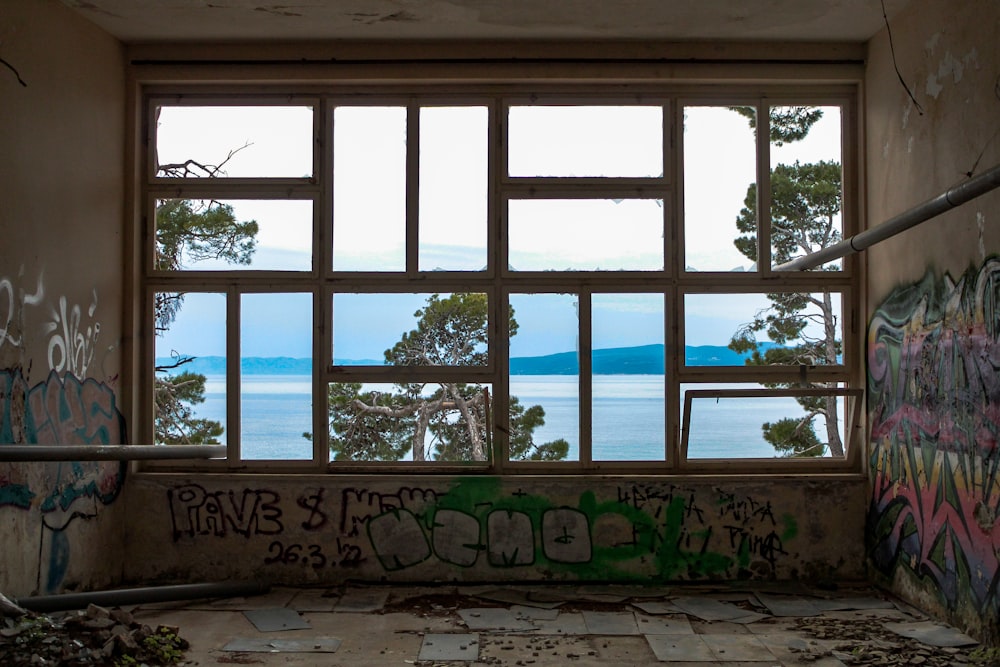 a run down room with graffiti on the walls