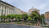 An urban streetscape with thoughtful public spaces and green pathways in an Albanian town.