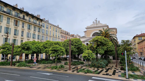 An urban streetscape with thoughtful public spaces and green pathways in an Albanian town.