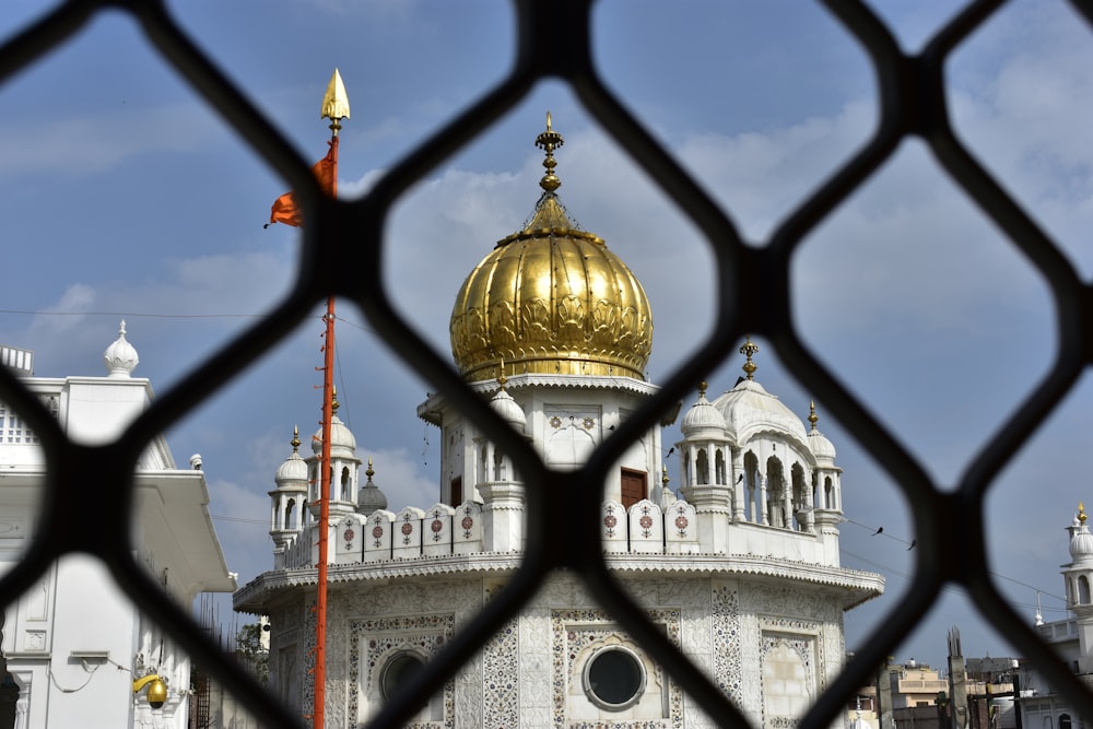 a golden dome on top of a white building