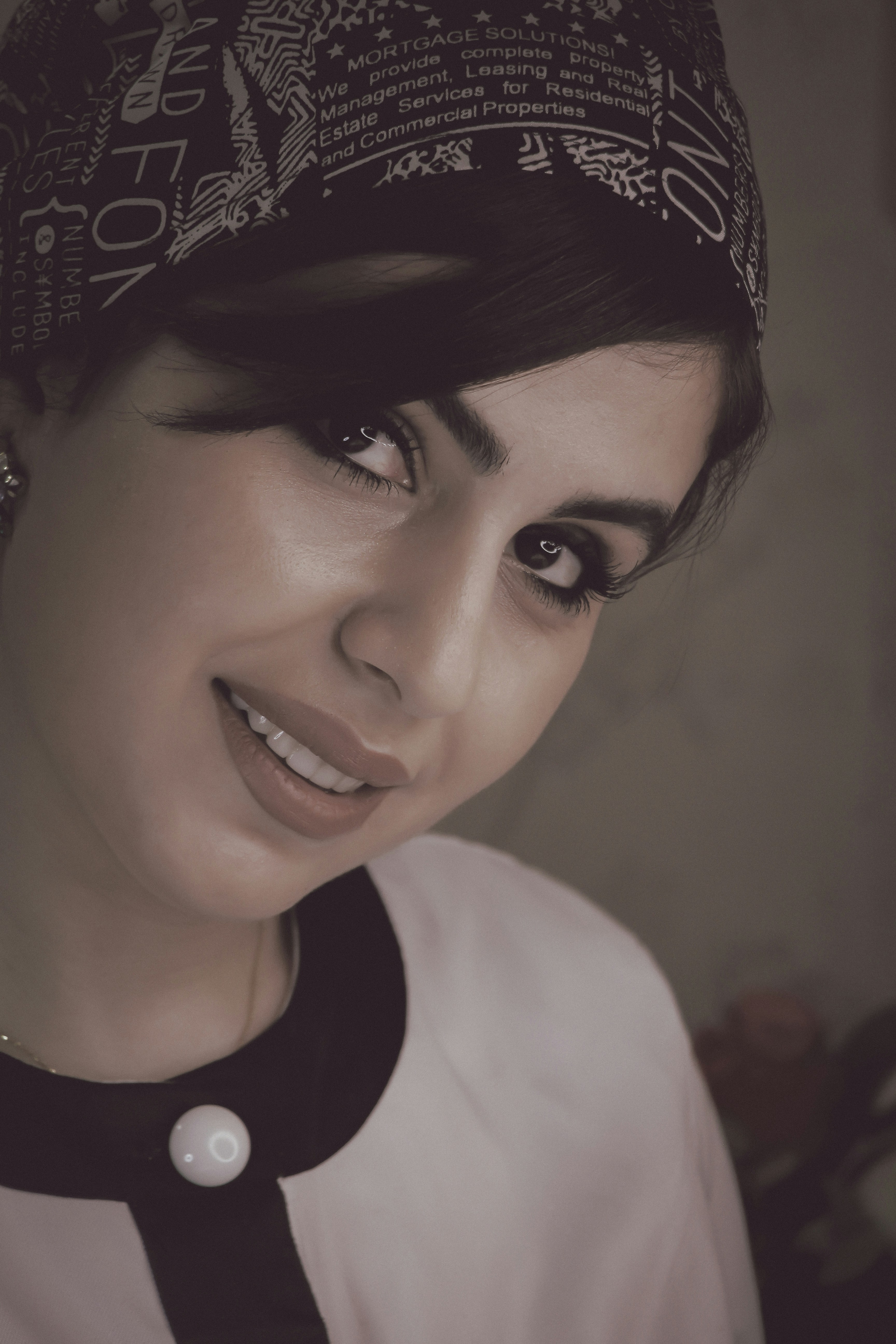 a woman wearing a black and white shirt and a black and white hat