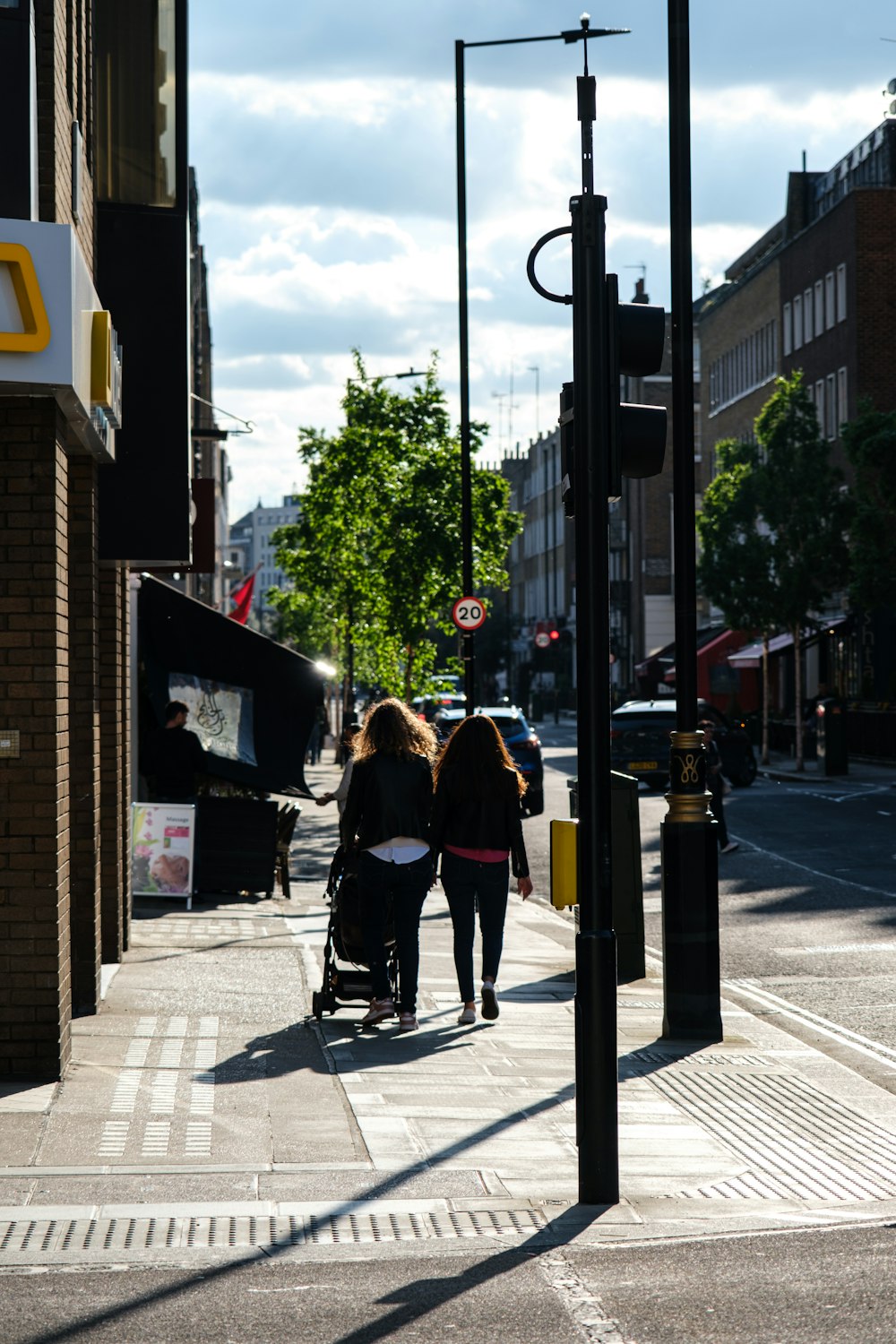 a couple of women walking down a street