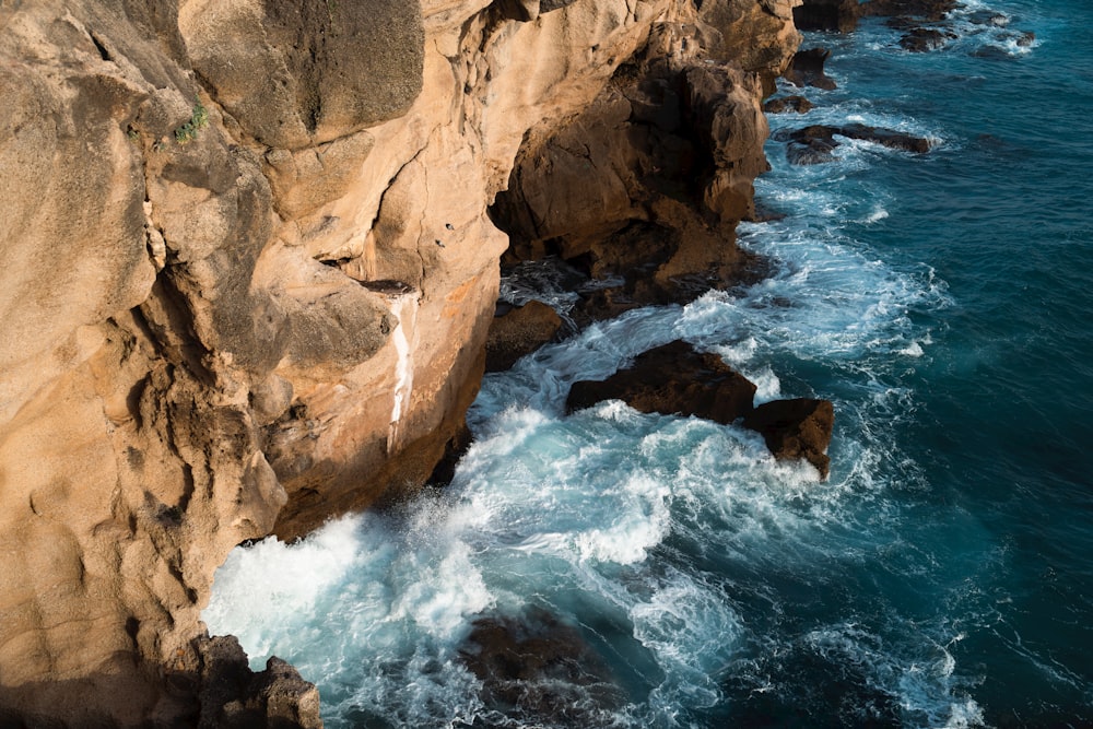 an aerial view of the ocean and cliffs