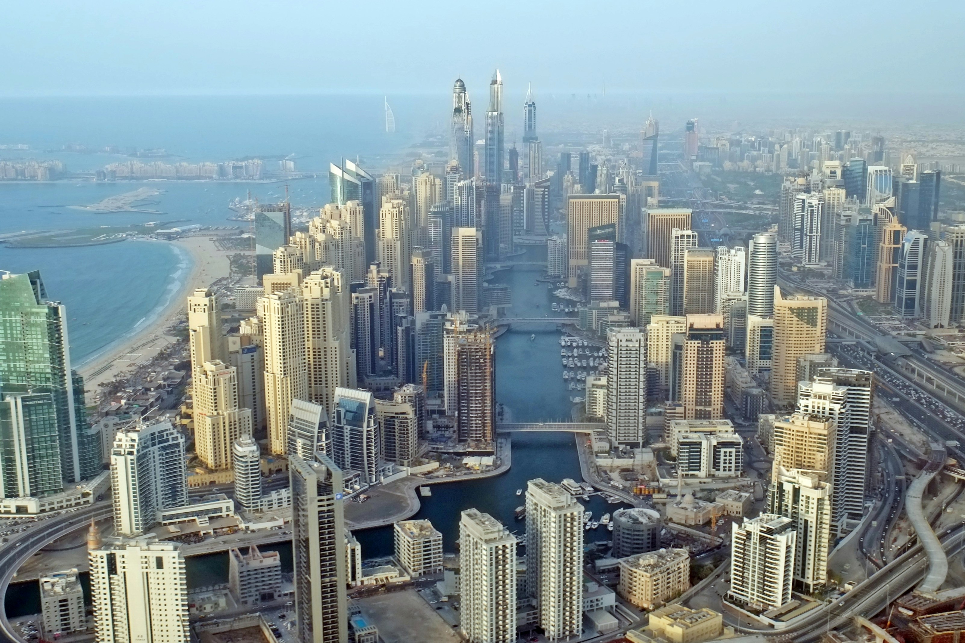 Parasailing over Dubai Marina with aerial view of waterfront