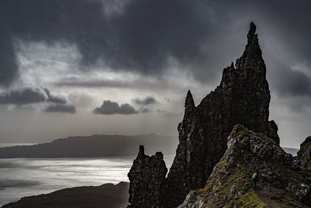 a rocky outcropping with a body of water in the distance