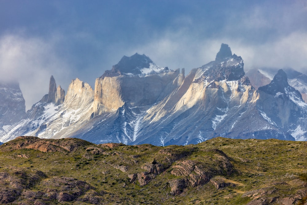 a mountain range covered in snow and clouds