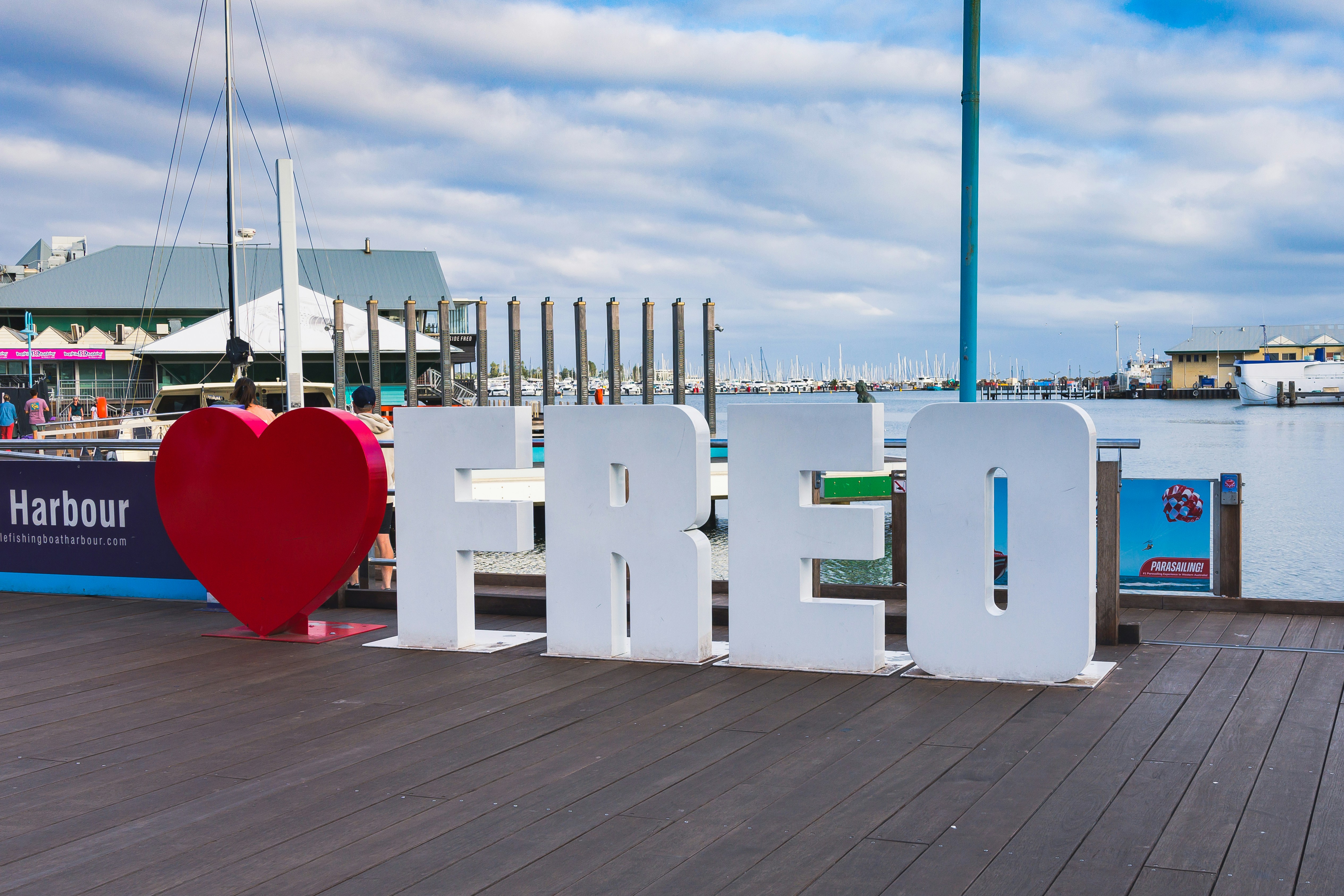 a large sign that says love sits on a dock