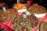 A vibrant market stall in Nigeria showcasing dried snail meat ready for export.