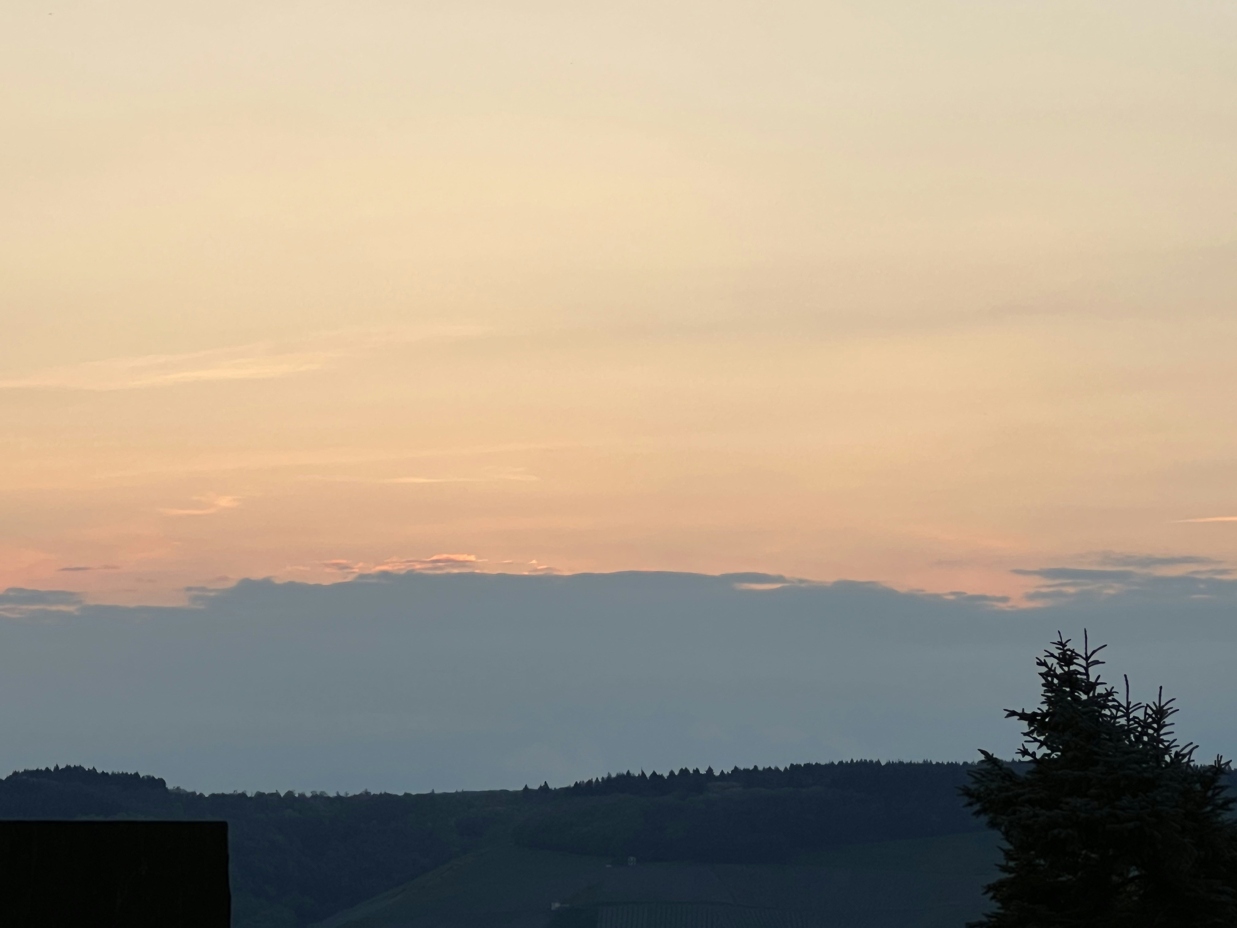 Soft watercolor landscape with terracotta earth tones, gentle rolling hills and warm sunset sky