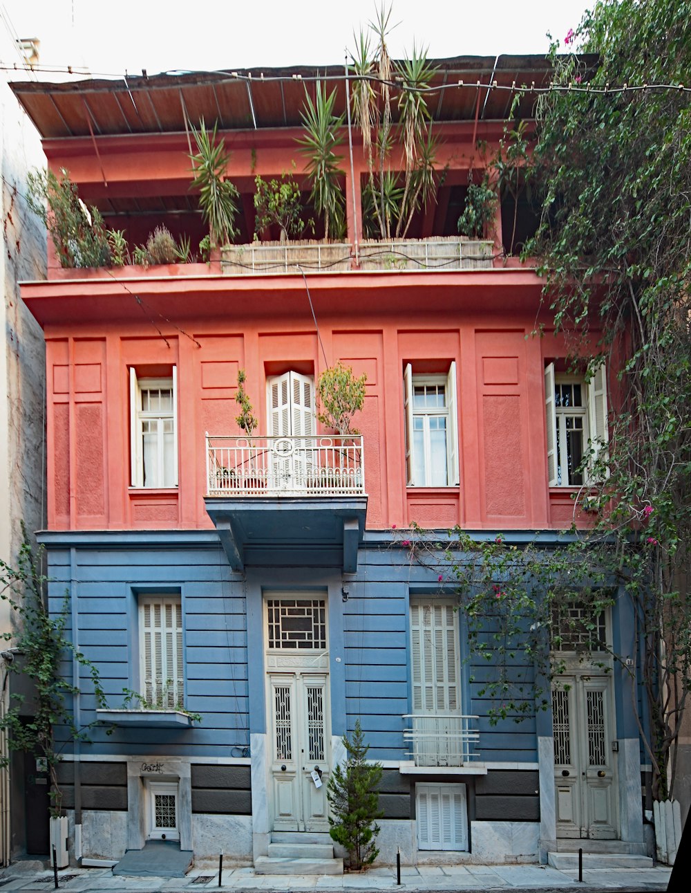 a blue and red building with a balcony