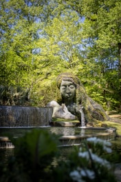 a water fountain with a statue of a woman in the middle of it